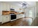 The kitchen features stainless appliances, farmhouse sink and plenty of cabinet space for storage and meal preparation at 407 Doris Dr, Woodstock, GA 30188