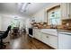 The kitchen features a farmhouse sink, stainless steel appliances, and a dining area, perfect for cooking and entertaining at 407 Doris Dr, Woodstock, GA 30188