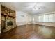 Inviting living room boasts a stone fireplace, wood floors, and plenty of natural light at 407 Doris Dr, Woodstock, GA 30188