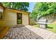 Brick patio featuring steps up to the back door, a wooden walkway and a stainless steel grill at 407 Doris Dr, Woodstock, GA 30188