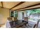 Covered patio with outdoor dining set, grill, brick patio, and lush greenery at 407 Doris Dr, Woodstock, GA 30188
