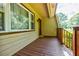 Charming covered porch with wooden railings and a cozy entryway, perfect for relaxing outdoors at 407 Doris Dr, Woodstock, GA 30188