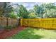 Fenced backyard area with gated access provides privacy and security at 407 Doris Dr, Woodstock, GA 30188