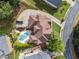 Bird's eye view of the property featuring a pool, luscious greenery, and a neatly kept lawn at 3410 Enclave Mill Ct, Dacula, GA 30019