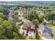 Extensive neighborhood with mature trees surrounds a gorgeous house with a pool and deck at 3410 Enclave Mill Ct, Dacula, GA 30019