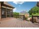 Wide shot of the back deck made of wood, railings, and access to the pool below at 3410 Enclave Mill Ct, Dacula, GA 30019