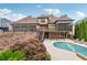 Elegant home boasts a private pool, screened porch, multi-level deck, and manicured landscaping at 3410 Enclave Mill Ct, Dacula, GA 30019