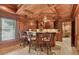 Home bar with seating, granite countertop, wooden cabinets, and coffered ceilings at 3410 Enclave Mill Ct, Dacula, GA 30019