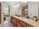 Bright bathroom featuring double sinks and a large mirror and doorway to another room at 3410 Enclave Mill Ct, Dacula, GA 30019