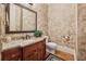 Bathroom featuring an intricately painted wall treatment, a granite sink, and hardwood flooring at 3410 Enclave Mill Ct, Dacula, GA 30019