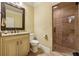 Bathroom with vanity and granite countertop, toilet, and tiled glass shower enclosure at 3410 Enclave Mill Ct, Dacula, GA 30019