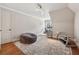 Bright office or bedroom with large rug, stylish desk, and natural light at 3410 Enclave Mill Ct, Dacula, GA 30019