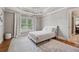 Bedroom features a white bed, bright window, and doorway to another room at 3410 Enclave Mill Ct, Dacula, GA 30019