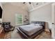 Modern bedroom with a black platform bed, a window, and a stylish chair on a patterned rug at 3410 Enclave Mill Ct, Dacula, GA 30019