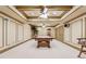 Spacious billiards room with coffered ceilings, ceiling fans, and elegant wainscoting at 3410 Enclave Mill Ct, Dacula, GA 30019