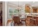 Bright breakfast nook boasts a chandelier, wooden table, and views of the backyard at 3410 Enclave Mill Ct, Dacula, GA 30019