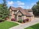 Beautifully landscaped lawn highlights the stone and brick accents of this home's front elevation at 3410 Enclave Mill Ct, Dacula, GA 30019