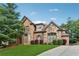 Beautiful brick home with stone accents, a manicured lawn, and a paved driveway at 3410 Enclave Mill Ct, Dacula, GA 30019