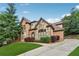 Beautiful brick home with stone accents, a manicured lawn, and a paved driveway at 3410 Enclave Mill Ct, Dacula, GA 30019