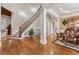 Grand foyer with hardwood floors, staircase with iron railings, and decorative columns at 3410 Enclave Mill Ct, Dacula, GA 30019