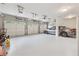 Spacious three-car garage featuring high ceilings, automatic doors, and epoxy floors at 3410 Enclave Mill Ct, Dacula, GA 30019