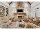 Comfortable living room showcasing stone fireplace, vaulted ceiling, and custom built-in shelving at 3410 Enclave Mill Ct, Dacula, GA 30019