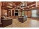 Cozy living room boasts a coffered ceiling, wood accents, comfortable seating, and a large television at 3410 Enclave Mill Ct, Dacula, GA 30019