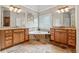 Luxury bathroom showcasing double vanities, a soaking tub, and elegant tile flooring at 3410 Enclave Mill Ct, Dacula, GA 30019
