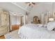 Spacious main bedroom features tray ceilings, hardwood floors, and ensuite bathroom at 3410 Enclave Mill Ct, Dacula, GA 30019