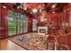 Luxurious office with wood-paneled walls, fireplace, and large window at 3410 Enclave Mill Ct, Dacula, GA 30019