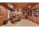 Wood paneled office with coffered ceilings, built-in bookshelves, and large desk at 3410 Enclave Mill Ct, Dacula, GA 30019