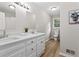 Bathroom with double vanity, modern lighting, wood-look floor and neutral decor at 103 Seabolt Dr, Locust Grove, GA 30248