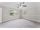 This light-filled bedroom includes gray walls, carpet, white trim, and ample natural light at 103 Seabolt Dr, Locust Grove, GA 30248