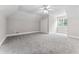 Neutral bedroom featuring carpet, a ceiling fan, natural light, and ample space at 103 Seabolt Dr, Locust Grove, GA 30248