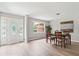 Bright dining area with wood floors and a decorative front door at 103 Seabolt Dr, Locust Grove, GA 30248