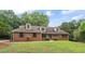 Charming one-story brick home with a well-manicured lawn and mature trees at 103 Seabolt Dr, Locust Grove, GA 30248