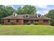 Charming one-story brick home with a well-manicured lawn and mature trees at 103 Seabolt Dr, Locust Grove, GA 30248