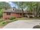 Back exterior view of home with brick facade, mature landscaping, and backyard patio with gazebo at 103 Seabolt Dr, Locust Grove, GA 30248