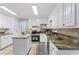Spacious kitchen with granite counters, stainless steel appliances, and bright, white cabinets at 103 Seabolt Dr, Locust Grove, GA 30248