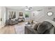 Bright living room features a ceiling fan, neutral paint, and stairs to the upper level at 103 Seabolt Dr, Locust Grove, GA 30248