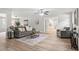 Open-concept living room with hardwood floors and lots of natural light streaming through the windows at 103 Seabolt Dr, Locust Grove, GA 30248