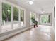 Bright sun room with tile flooring, windows with backyard views, and ceiling fans at 103 Seabolt Dr, Locust Grove, GA 30248