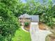 Aerial view of a brick home, showcasing its manicured lawn and tree-lined surroundings at 135 Crimson Rdg, Tyrone, GA 30290
