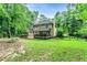 Back exterior and lawn with fenced backyard, and covered porch at 135 Crimson Rdg, Tyrone, GA 30290