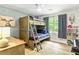 Bright bedroom with a bunk bed, natural light, and bookshelves at 135 Crimson Rdg, Tyrone, GA 30290