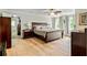 Spacious bedroom featuring a ceiling fan, wood floors, and walk-in closet at 135 Crimson Rdg, Tyrone, GA 30290