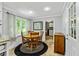 Cozy breakfast nook features a round wood table with seating for four and natural light at 135 Crimson Rdg, Tyrone, GA 30290