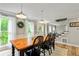 Bright dining room with wooden table and chairs, white wainscoting, and stairs to the entry at 135 Crimson Rdg, Tyrone, GA 30290