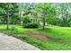 Landscape view of the home, wooded lot, and front yard at 135 Crimson Rdg, Tyrone, GA 30290