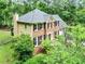 Elevated angle view of a home surrounded by mature trees and lush landscaping at 135 Crimson Rdg, Tyrone, GA 30290
